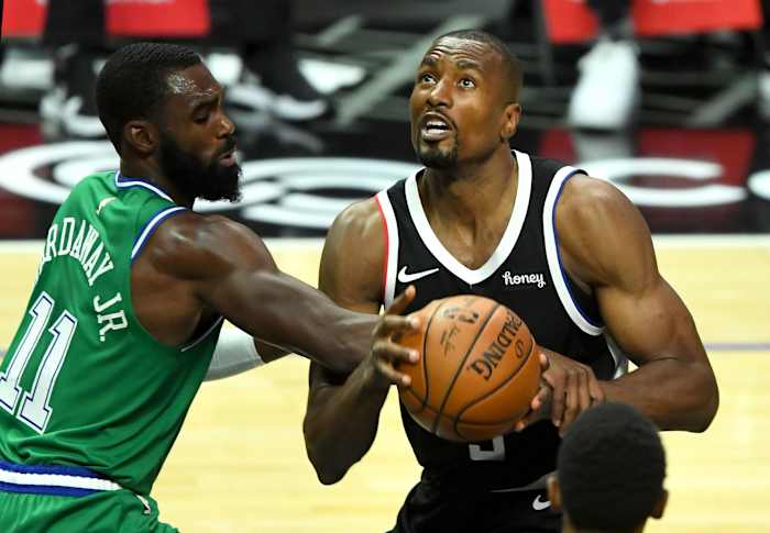 Dec 27, 2020; Los Angeles, California, USA; Los Angeles Clippers forward Serge Ibaka (right) is fouled by Dallas Mavericks guard Tim Hardaway Jr. (11) in the first half at Staples Center. Mandatory Credit: Jayne Kamin-Oncea-USA TODAY Sports